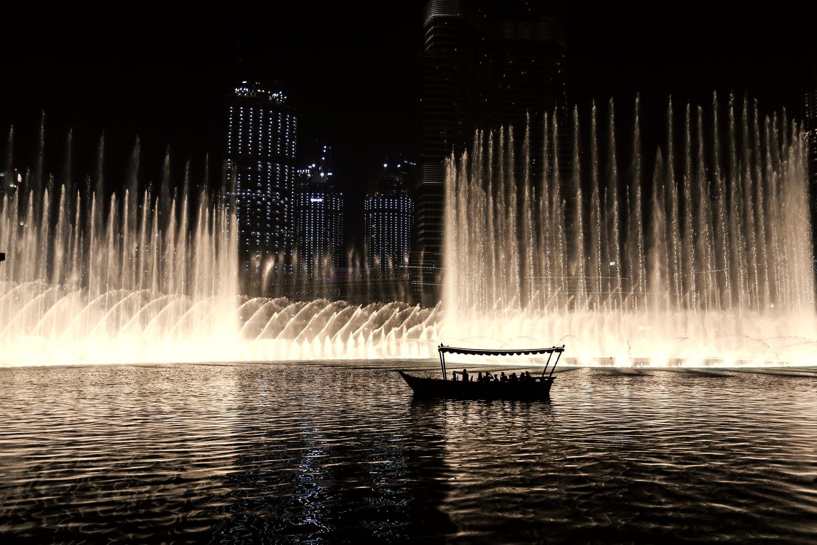 A boat on the Burj Lake during the fountain show