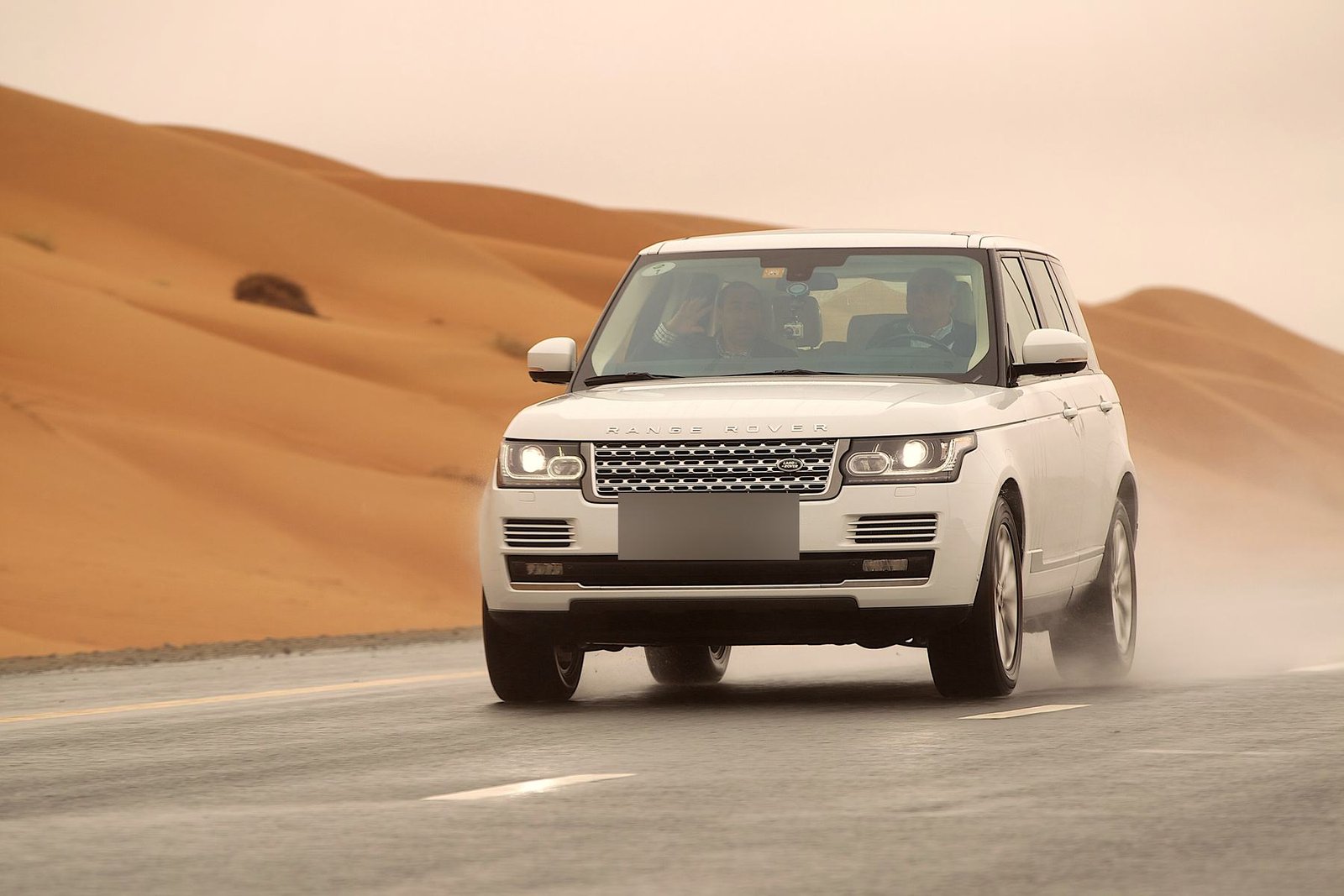 A white SUV crossing the desert