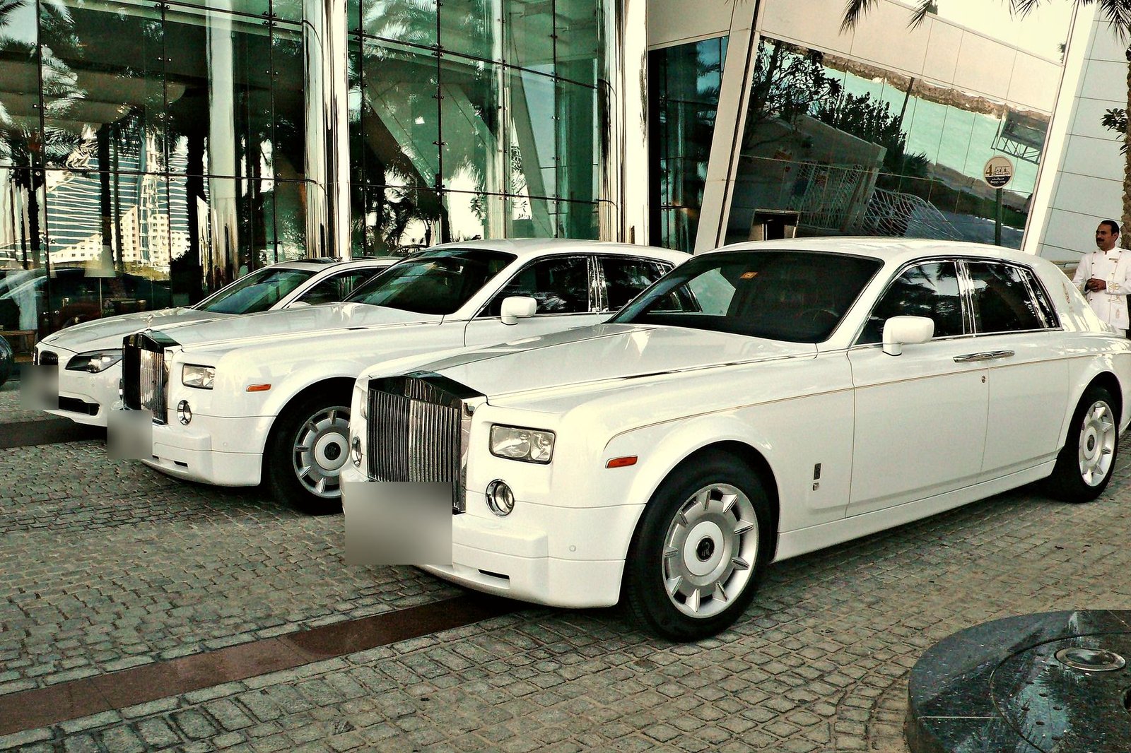 White Rolls-Royce Phantoms outside a hotel